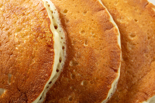 A top down view of a stack of pancakes, as a background.