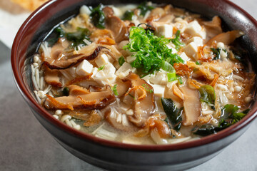 A closeup view of a bowl of udon soup.