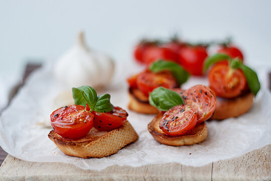 Close-up of toasted bruschetta with cherry tomatoes, basil and garlic