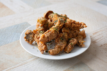 A view of a plate of gluten-free fried shimeji mushrooms.
