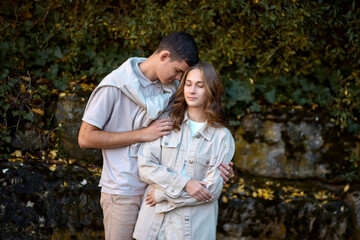 Embracing Teen Love in the Greenery of the Park.
