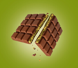 Dubai chocolate broken into two halves in the air on a green background. Dubai chocolate is made...