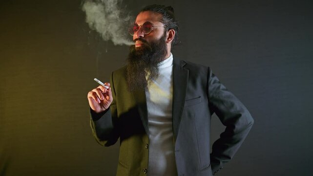 Elegant tycoon smokes into silent swagger indoor