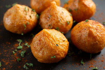 A closeup view of a plate of fried fish balls.