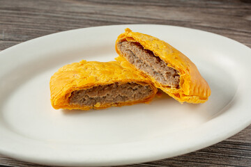 A view of a plate of a Jamaican patty.