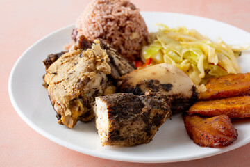 A closeup view of a plate of jerk chicken.