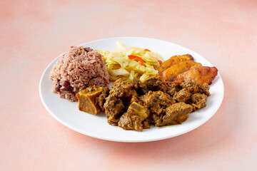 A view of a curry goat entree plate.