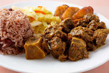 A closeup view of a plate of curry goat.