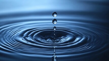 Water droplet creating ripples in a calm blue surface showcasing tranquility and serenity water reflection concept