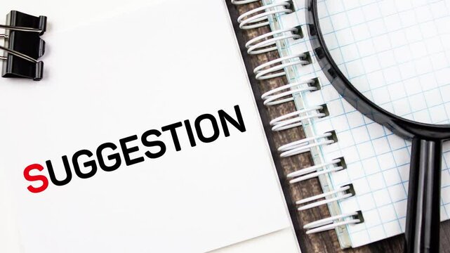 SUGGESTION text,word inscription on a pad with a magnifying glass,animation.