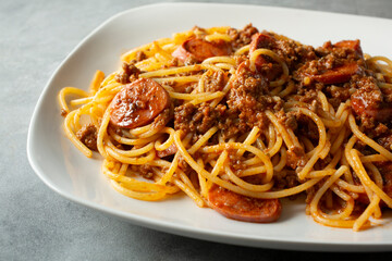 A closeup view of a plate of Filipino spaghetti.