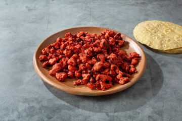 A view of a plate of chopped al pastor taco meat.
