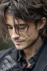 Obraz premium A man with long hair and a tattoo on his neck