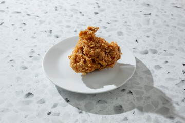 A view of a fried chicken wing, on a plate.
