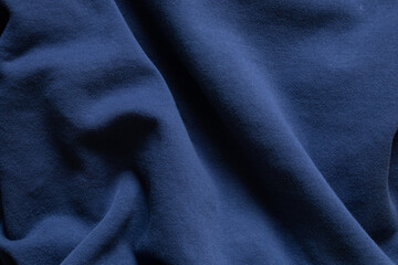Soft blue wrinkled fabric as background , blue sweater