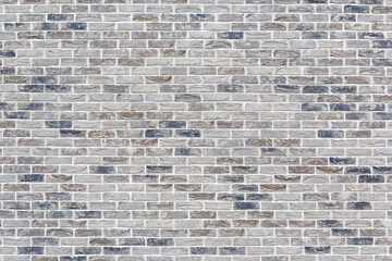 The wall is made of beige and gray decorative ceramic bricks or tiles