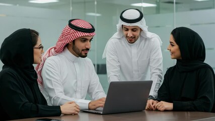 Saudi business team in traditional attire collaborating on laptop in office, ideal for teamwork, corporate planning, or business culture in Middle East settings.