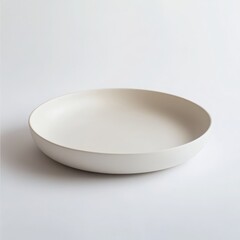 A simple shallow cream colored bowl isolated on white background