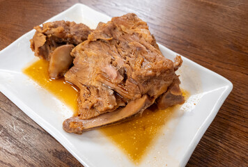 A dish of soft and juicy slow cooked pork bone meat served in a Chinese restaurant.