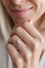 A woman wearing a rose gold engagement ring with a pear shaped diamond