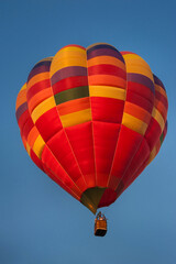 Fototapeta premium Sunlight highlights the colorful colors of the balloon's dome in the sky.