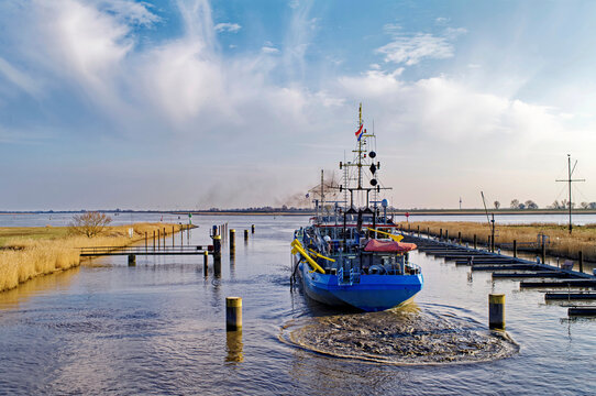 Dredger dredging the river Ems at the Oldersum lock, East Frisia, Lower Saxony, Germany