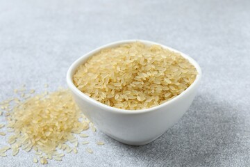 Raw brown rice in bowl on the table