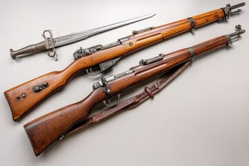 An overhead shot shows two Swiss Schmidt-Rubin K31 rifles and bayonet on a grey surface, showcasing the craftsmanship and history of these iconic firearms.