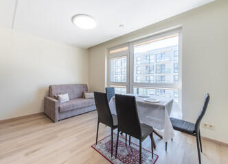 Modern Dining Room with Large Windows and Minimalist Interior Design
