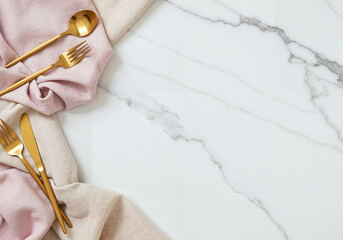 Elegant table setting with gold cutlery on marble background  