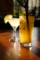 Refreshing tropical cocktails on a wooden table in warm natural light
