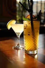 Refreshing tropical cocktails on a wooden table in warm natural light
