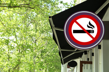 No Smoking sign on building wall outdoors