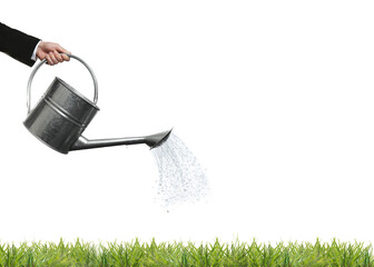 Businessman pouring water with watering can onto green grass against white background