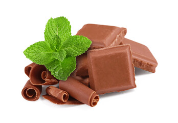 Milk chocolate pieces, curls and mint leaves on white background