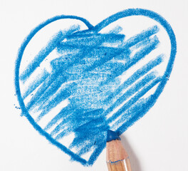Heart drawn with blue pencil on white paper, close up