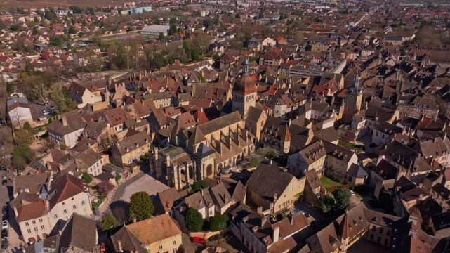 Early spring light shining over rooftops in Beaune France. Aerial drone video