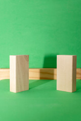 Still life with wooden blocks on green background	