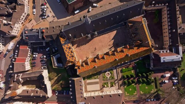 Drone over landmark hospice with patterned tiles France. Aerial drone video