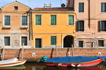 Moored boats on the Rio di San Nicolò canal in the sestiere of Dorsoduro, with the typical...