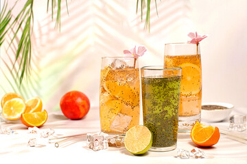 Modern still life with citrus fruits. Diet vegan cocktail with chia seeds, orange, lime, violet and...