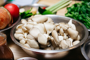 Fresh Oyster Mushrooms in Metal Bowl.