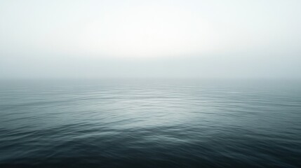 Obraz premium A quiet, misty morning at sea, the horizon barely visible in the fog --ar 16:9 --v 6.1 Job ID: 72a3487f-068b-4670-aba2-5683ddc5dfd1
