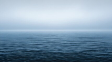 Obraz premium A quiet, misty morning at sea, the horizon barely visible in the fog --ar 16:9 --v 6.1 Job ID: 72a3487f-068b-4670-aba2-5683ddc5dfd1