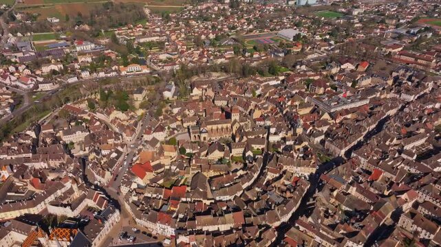 Daytime drone shot of Beaune old town with tiled rooftops. Aerial drone video