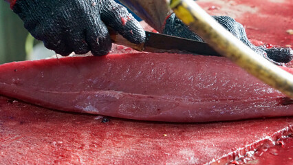 preparing fresh tuna steak at the fish market
