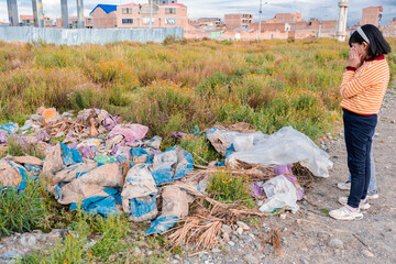 latin children looking at garbage in their city in latin america, bolivia - garbage concept