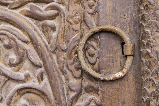 Saudi Arabia, Mecca, Jeddah, Al-Balad. Metal pull on a wooden door in the Al-Balad district.