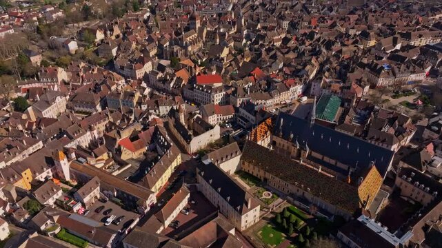 Iconic glazed roof of Hotel-Dieu de Beaune from above. Aerial drone video
