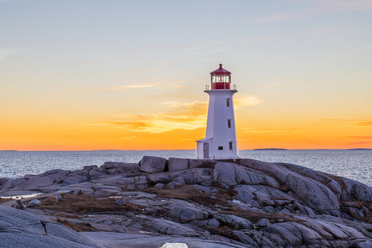 Peggy's Cove Lighthouse in winter at sunset, Nova Scotia, Canada.